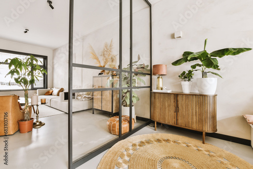 House with lampshade and plants on cabinet photo