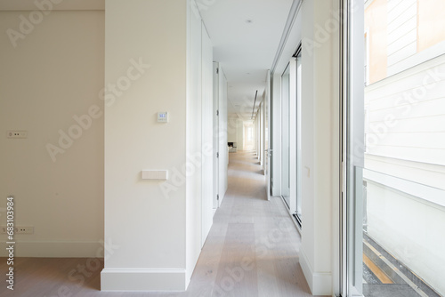 Penthouse with long hallway and bright windows photo