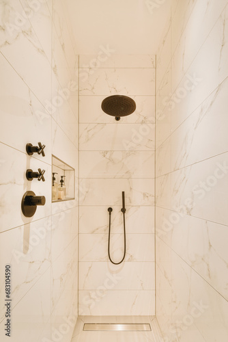 Shower cabin with marble walls and showerhead