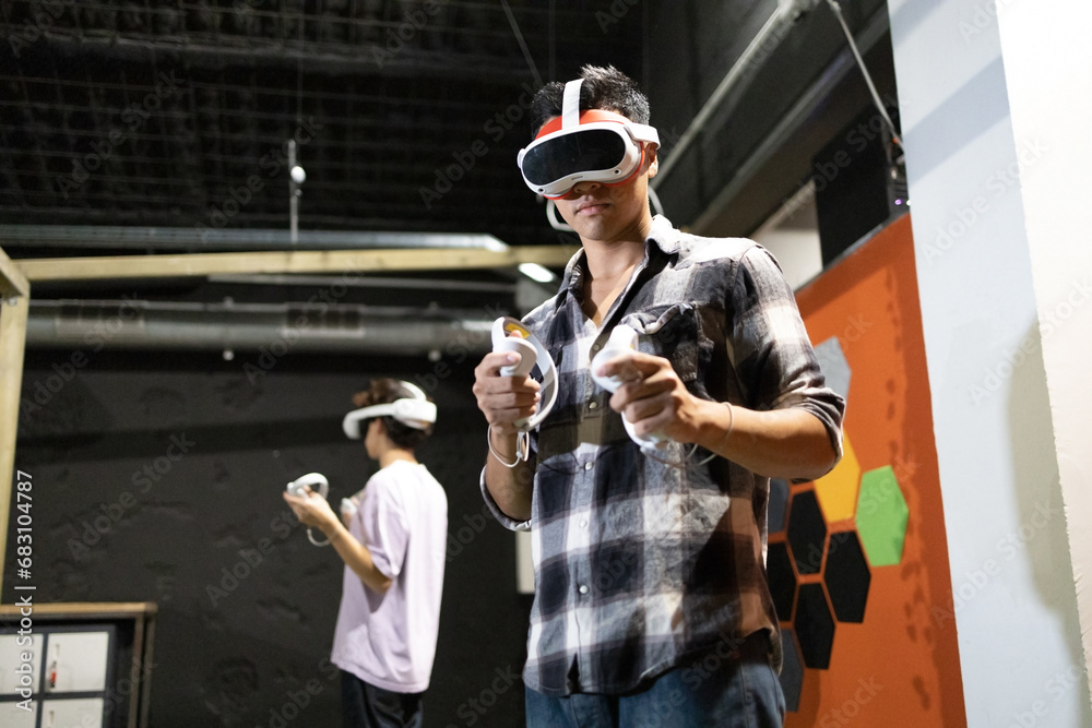 Young adults immersed in virtual reality gaming Young adults immersed in virtual reality gaming