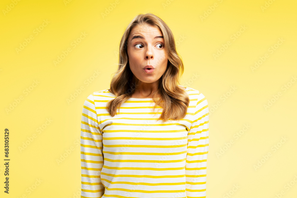Portrait of surprised young young woman looking away isolated on yellow background. Shopping concept Portrait of surprised young young woman looking away isolated on yellow background. Shopping concept
