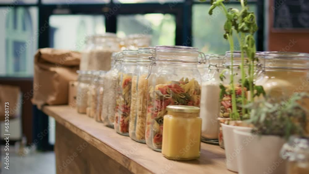 Close up on bulk products in reusable jars used by zero waste eco store to eliminate single use plastics, sustainable lifestyle. Local organic shop storing pantry supplies in nonpolluting packaging.