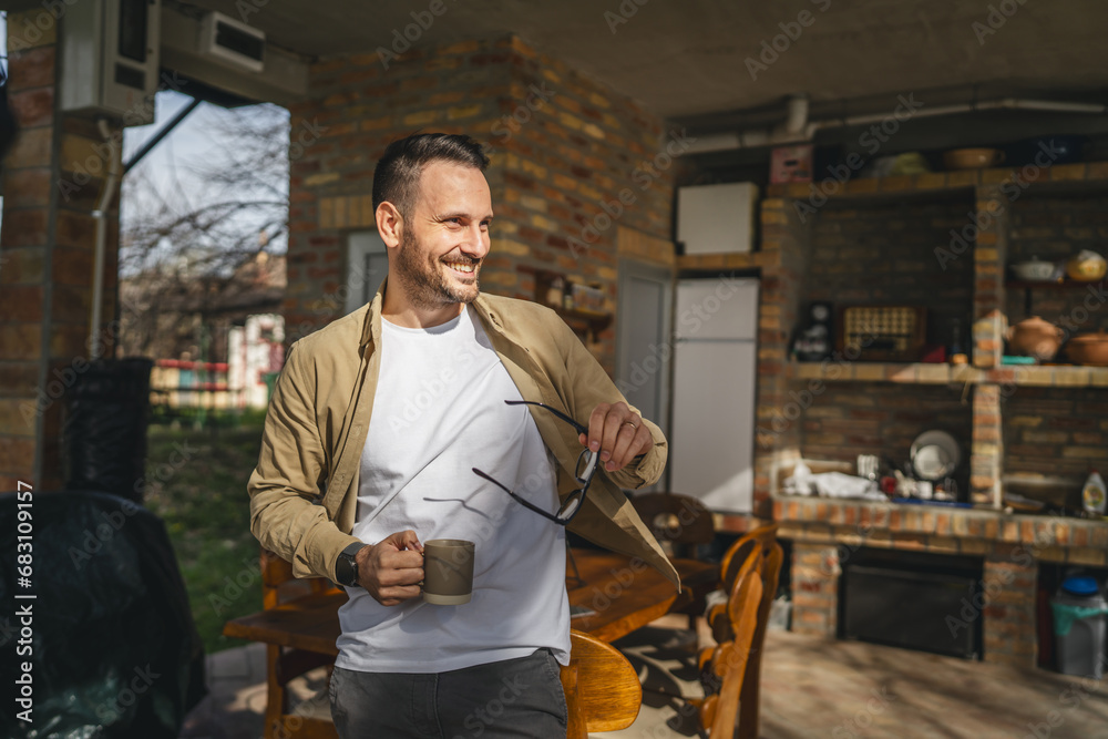 One man stand at his house in sunny day or morning enjoy cup of coffee