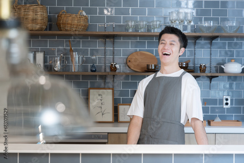 キッチンに笑顔で立つ男性　店舗の売上アップなどのイメージ photo
