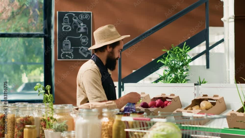 Happy man spraying fresh produce to preserve aroma and smell, zero waste supermarket vendor. Owner with hat and apron taking care of fruits and vegetables placed for sale, neighborhood shop. Happy man spraying fresh produce to preserve aroma and smell, zero waste supermarket vendor. Owner with hat and apron taking care of fruits and vegetables placed for sale, neighborhood shop.