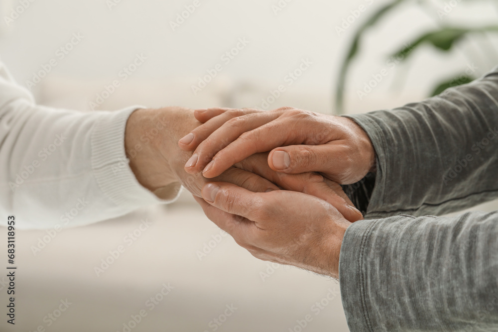 Fototapeta premium Trust and support. Men joining hands on blurred background, closeup