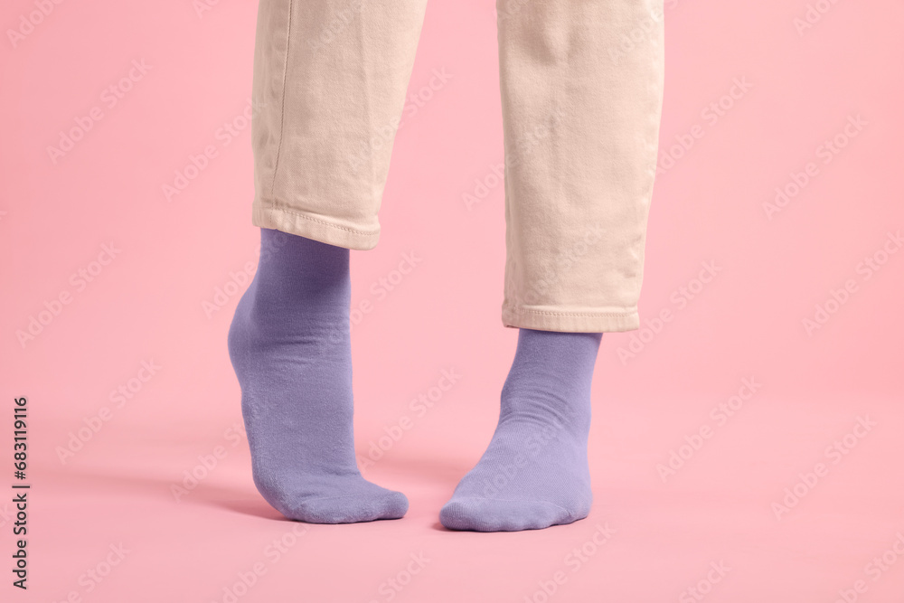 Woman in stylish purple socks and pants on pink background, closeup Woman in stylish purple socks and pants on pink background, closeup