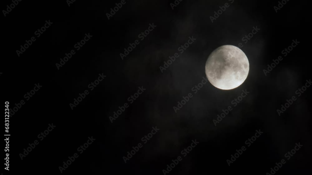 Moon shrouded by clouds against a dark sky, evoking mystery and the beauty of the cosmos. Moon shrouded by clouds against a dark sky, evoking mystery and the beauty of the cosmos.