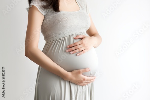 Close up, Pregnant woman stroking her belly, isolated on a white background