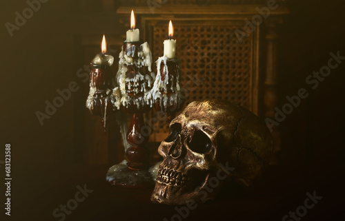 Old battered skull lies with an antique wooden candlestick. The concept of black magic, services from sorcerers and magicians photo