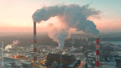 Aerial sunset view of heating plant and thermal power station. Combined modern power station for city district heating and generating electrical power. Industrial zone from above. photo