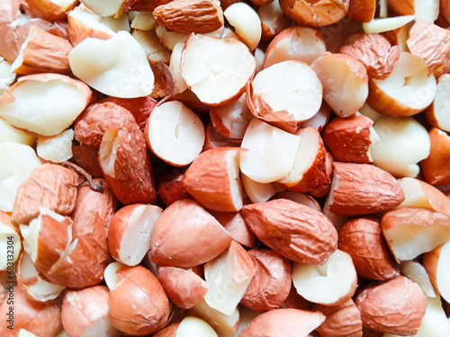 close up of pile of peanuts. peanut pieces. food background. dry peanuts