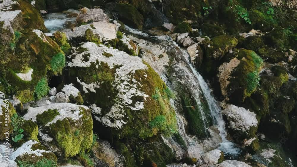 Blue cold water of mountain river in the Alps, Dolomites waterfall Blue cold water of mountain river in the Alps, Dolomites waterfall