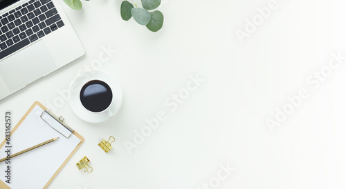 Top view office table desk workspace frame with green leaves eucalyptus, clipboard and coffee cup isolated on white background. Flay lay,  ideas, notes or plan writing concept