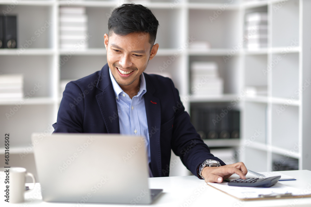 Businessman working with laptop on desk in office. Businessman working with laptop on desk in office.