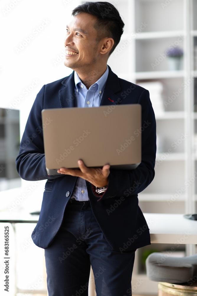 Portrait of a businessman using a laptop in the office. Portrait of a businessman using a laptop in the office.