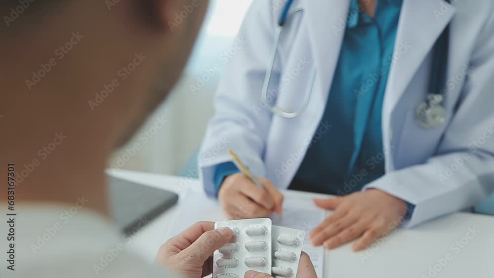 Asian caregiver nurse give consult to Caucasian senior woman patient. Attractive carer pharmacist hold medicine pills bottle, explain prescription to elderly mature grandmother in living room in house Asian caregiver nurse give consult to Caucasian senior woman patient. Attractive carer pharmacist hold medicine pills bottle, explain prescription to elderly mature grandmother in living room in house