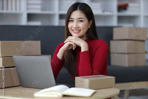 Attractive Asian woman starting a small online selling business at home.