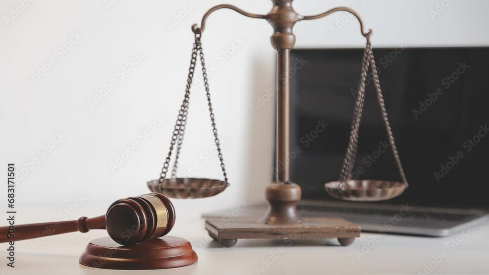 Business and lawyers discussing contract papers with brass scale on desk in office. Law, legal services, advice, justice and law concept picture with film grain effect Business and lawyers discussing contract papers with brass scale on desk in office. Law, legal services, advice, justice and law concept picture with film grain effect