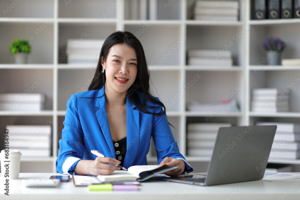 Portrait of an attractive Asian businesswoman in the office at work. Portrait of an attractive Asian businesswoman in the office at work.