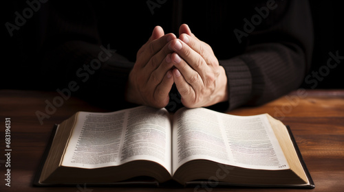 A man praying sincerely with religious book photo