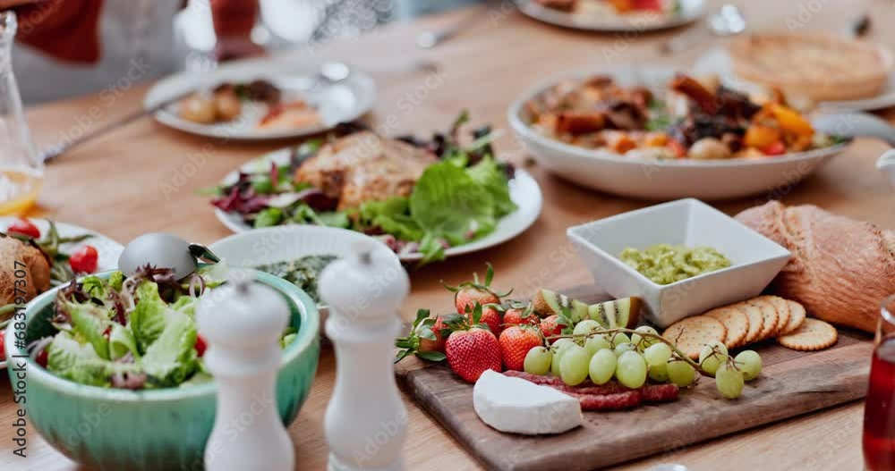 Table, food and hand of man at a family lunch, reunion or social gathering. Health, nutrition and closeup of people eating at a buffet for Christmas, party or brunch, event and celebration outdoor Table, food and hand of man at a family lunch, reunion or social gathering. Health, nutrition and closeup of people eating at a buffet for Christmas, party or brunch, event and celebration outdoor