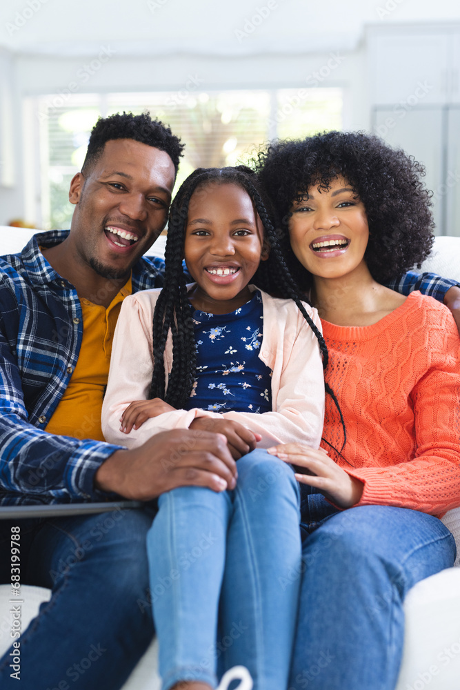 Portrait of happy african american family sitting on couch at home, copy space Portrait of happy african american family sitting on couch at home, copy space