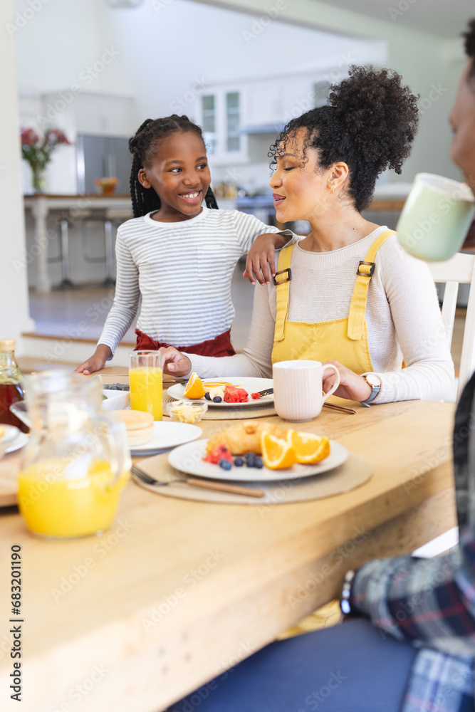 Happy african american family having fresh fruits snack in dining room at home, copy space Happy african american family having fresh fruits snack in dining room at home, copy space