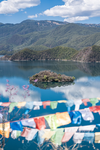 Buddhist prayer flags fluttering next to Lugu Lake in China