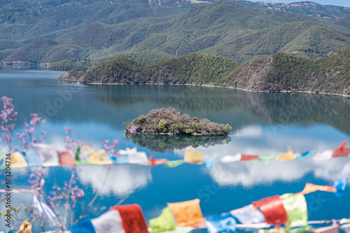 Buddhist prayer flags fluttering next to Lugu Lake in China photo