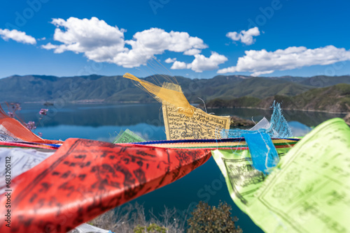 Buddhist prayer flags fluttering next to Lugu Lake in China photo