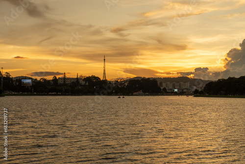 Sunset view of a Da Lat City with development buildings, transportation, market. Tourist city with center square of Da Lat city near Xuan Huong lake