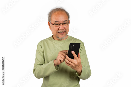 Portrait of happy mature senior Asian man wearing eyeglasses standing holding and using a smartphone to check mail and news from application isolated on white background.