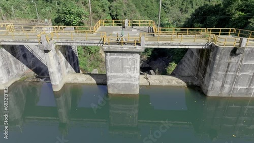 Aerial tilt down shot of Tireo Dam construction building with green water in Bonao photo