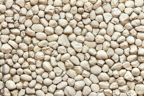 Close up shot of a beautifully textured stone wall.Typical natural stone wall, stones wall texture backdrop.Rock wall texture for pattern background. Shingle template wallpaper for designs background.