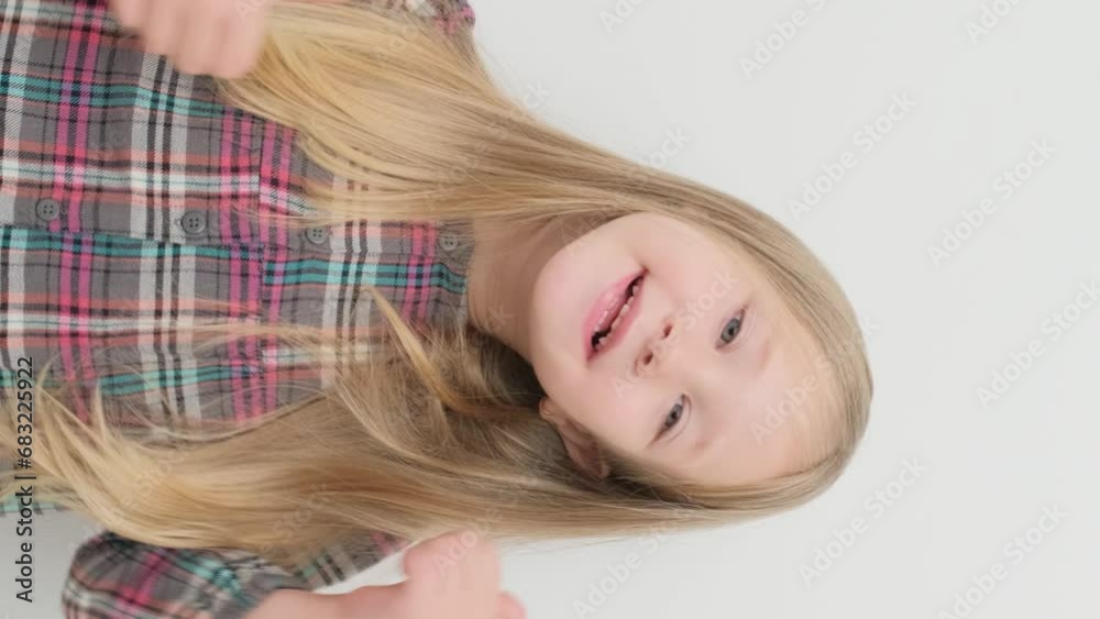 Little girl rejoices, pampers and smiles, close-up portrait. Vertical video. Little girl rejoices, pampers and smiles, close-up portrait. Vertical video.