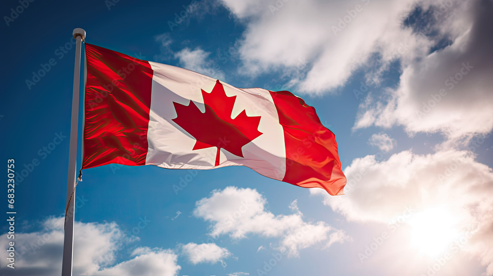 Canada flag flying on the blue sky