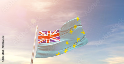 Tuvalu national flag waving in beautiful sky. The symbol of the state on wavy silk fabric.