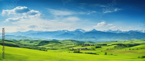 Beautiful landscape with green meadows and blue sky with clouds. © Rudsaphon