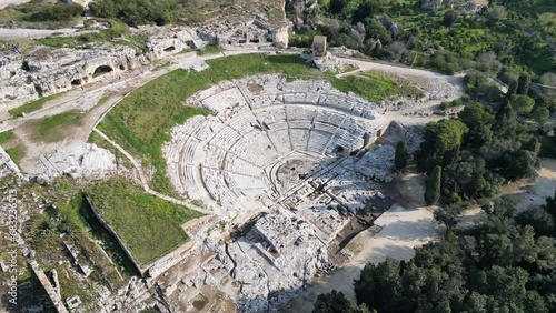 Tilting aerial view of ancient Greek theater in archaeological park in Syracuse, culture and history in Sicily Italy
 photo