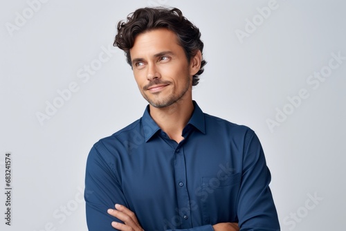 Contemplative Young Man in Blue Shirt on White Background