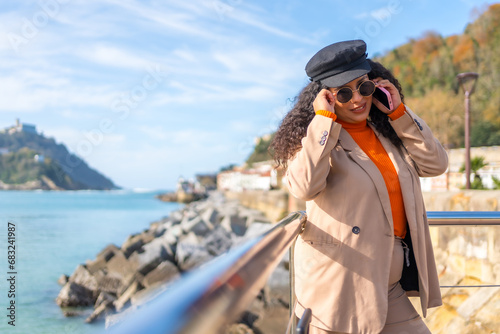 Chic woman enjoying a day of autumn in the coast