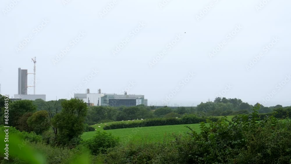 Closed Sellafield nuclear power station panning shot in summer rain. Closed Sellafield nuclear power station panning shot in summer rain.