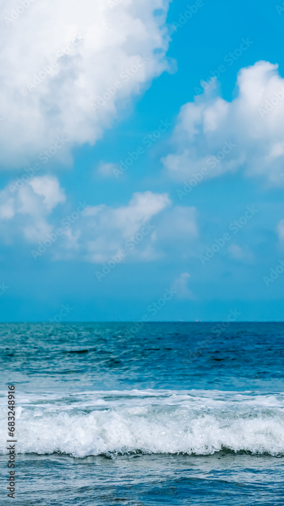 Turquoise clear sea view panorama blue sky white clouds close wave, beauty of nature, skyline. Vertical