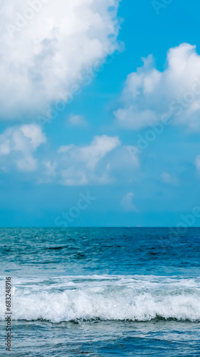 Fototapeta Naklejka Na Ścianę i Meble -  Turquoise clear sea view panorama blue sky white clouds close wave, beauty of nature, skyline. Vertical