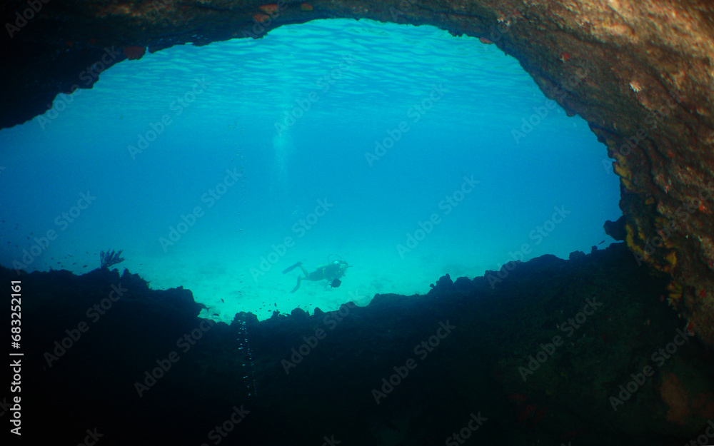 a woman diving in a cave in the caribbean sea