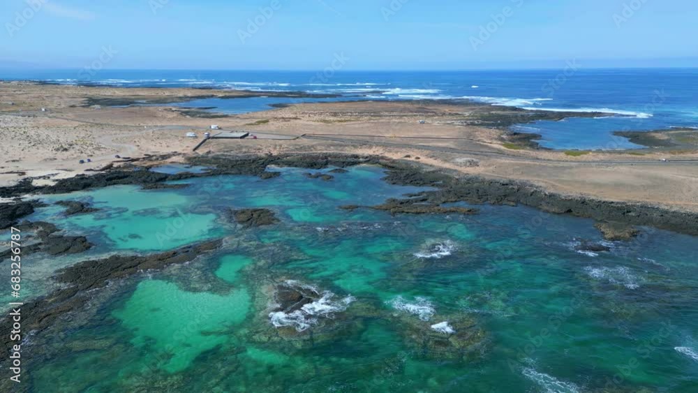 Aerial fly up orbital clip of the natural pools and volcanic rock formations near El Cotillo in Fuerteventura Spain Aerial fly up orbital clip of the natural pools and volcanic rock formations near El Cotillo in Fuerteventura Spain
