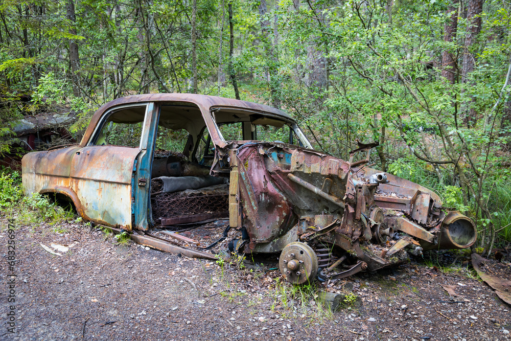 Abandoned car wreckage rotting in a forest Abandoned car wreckage rotting in a forest
