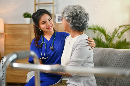 Quadro su tela Caring female doctor visiting senior woman patient at home