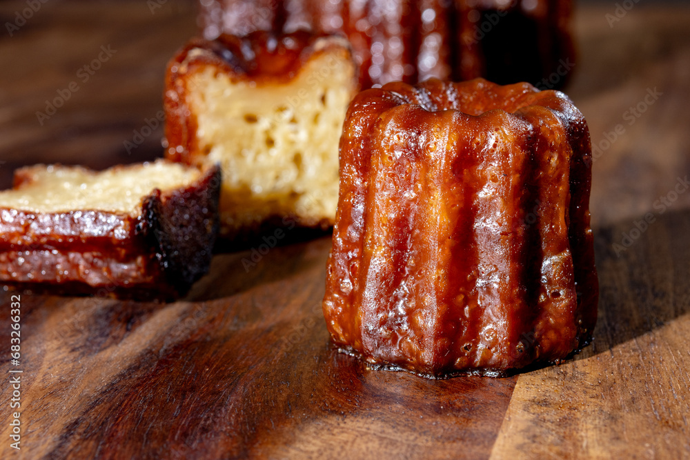 Canele, French pastry flavored with rum and vanilla, soft and tender custard center and dark, caramelized crust specialty of Bordeaux region, France Canele, French pastry flavored with rum and vanilla, soft and tender custard center and dark, caramelized crust specialty of Bordeaux region, France